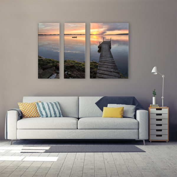 Photograph on a 3 panel canvas in the living room. Photograph of a dock by the lake during the morning sunrise.